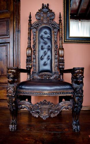 an ornate chair sitting on top of a wooden floor at Hotel Rural Orotava in La Orotava