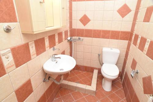 a bathroom with a toilet and a sink at Little Yard Studios & Apartments #3 in Naxos Chora