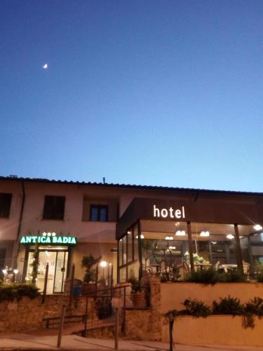 a hotel building with the moon in the sky at Holiday Rooms Antica Badia in Volterra