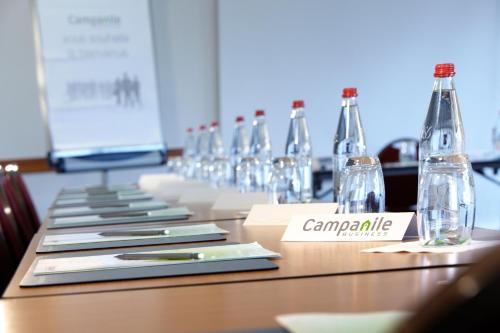 a long table with glasses and bottles on it at Campanile Lille Sud - Douai Cuincy in Cuincy