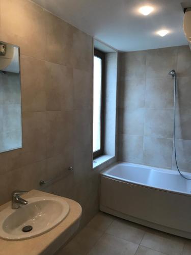 a bathroom with a sink and a bath tub at Sun Village Villa 13 in Byala