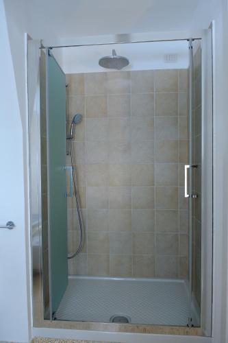 a shower with a glass door in a bathroom at Contrada Cappuccini in Ginosa