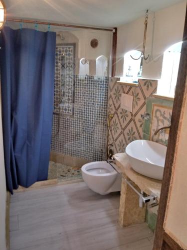 a bathroom with a toilet and a sink and a shower at La Terrazza on Acquaviva in Marittima