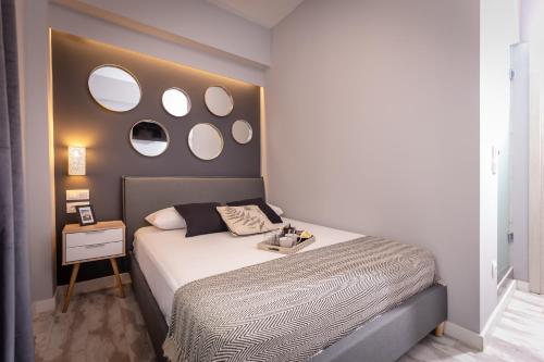 a bedroom with a bed with mirrors on the wall at Ionian City in Corfu Town