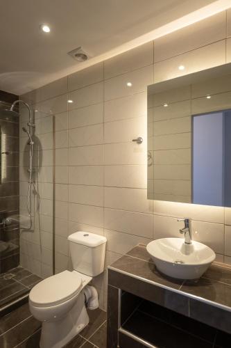 a bathroom with a toilet and a sink and a shower at Ionian City in Corfu Town