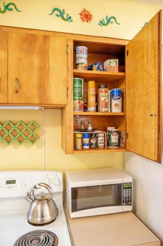 a kitchen with a stove and a microwave at Bright & Sunny Home Near Zion in Hurricane