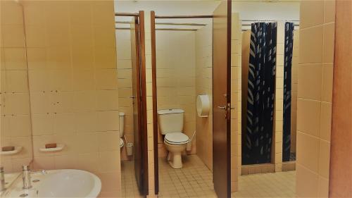 a bathroom with a toilet and a sink at VRS - Low Cost Beach Boat in Leça da Palmeira