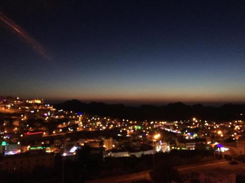 a view of a city lit up at night at Petra Guests Hotel in Wadi Musa