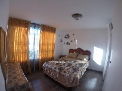 a bedroom with a bed and a chair in it at La Casa de Chamo in Arequipa