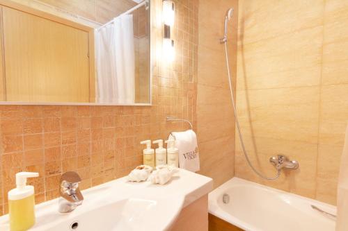 a bathroom with a sink and a mirror and a shower at VV Luxury Experience in Fourka