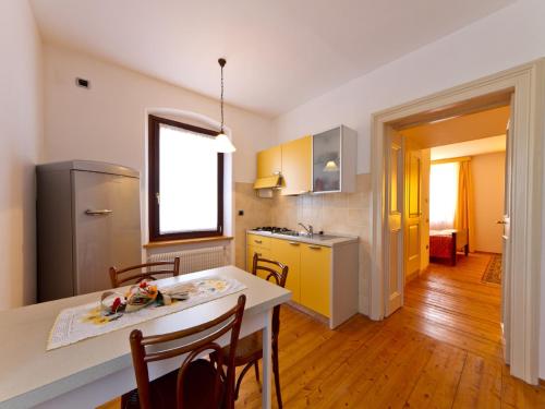 a kitchen with a table and chairs in a room at Villa Butussi - L'ospitalità del Vino in Corno di Rosazzo