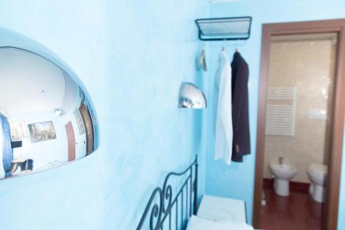 a bathroom with a mirror and a sink and a toilet at DomusAmor Colosseo in Rome