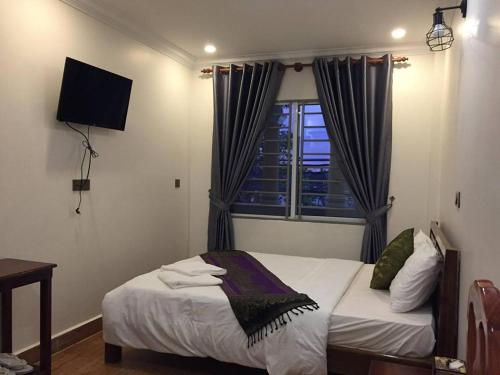 Una cama o camas en una habitación de TWIN HOME Guesthouse