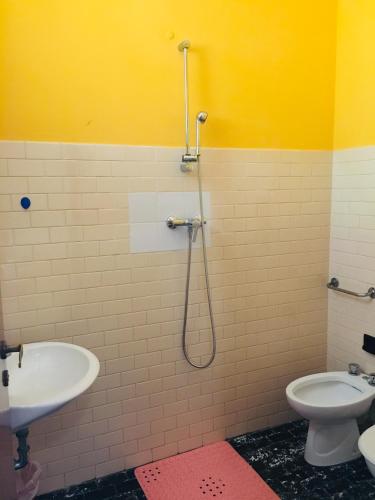 a bathroom with a shower and a sink and a toilet at Hotel Bellevue in Cesenatico