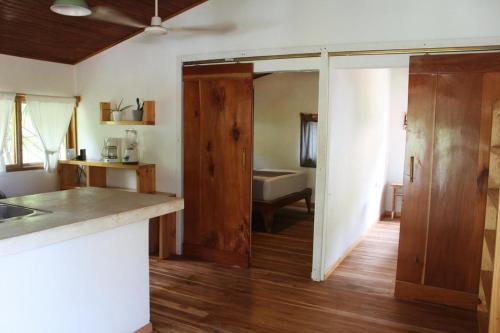 a kitchen with a door open to a bathroom at Casa SILURI UP in Santa Teresa Beach
