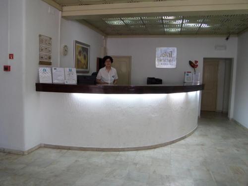 a woman standing at a counter in a room at Mirachoro Albufeira in Albufeira