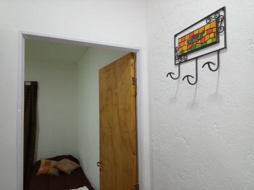 a room with a door and a painting on the wall at Departamentos Pachamama in Tunuyán