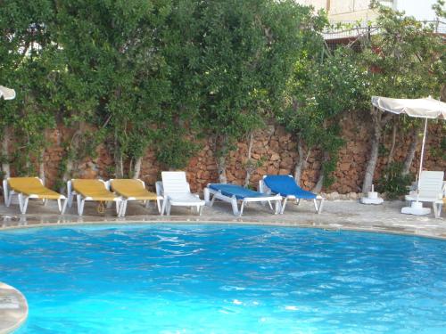 a group of chairs and a swimming pool at Mirachoro Albufeira in Albufeira