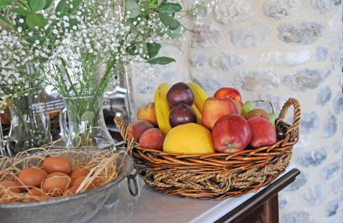a basket of fruit sitting on a table with eggs at Archontiko Hatzipanayioti in Leonidion