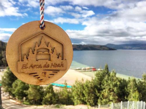 a disc hanging from a string with a view of a lake at El Arca de Noah in Tota