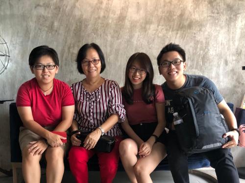 a group of four people sitting on a bench at Goodnight Poshtel + Free Netflix in Hat Yai