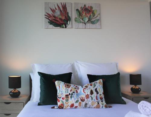 a bedroom with a bed with pillows and two lamps at Stunning Views Sydney Olympic Park in Sydney