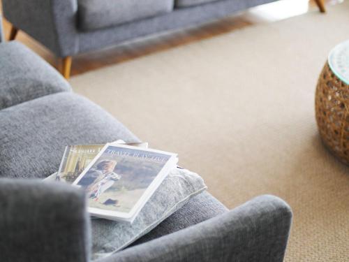 a magazine sitting on the lap of a couch at Barrenjoey Beach House in Palm Beach
