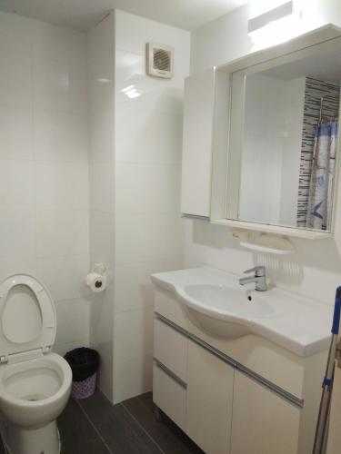 a bathroom with a toilet and a sink and a mirror at Grandbeach2 B52 By malai in Mae Pim