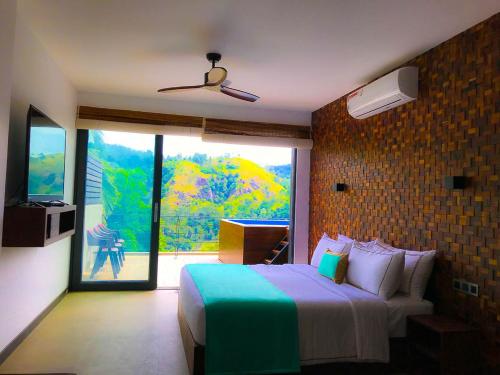 a bedroom with a bed and a large window at Ella Flower Garden Resort in Ella