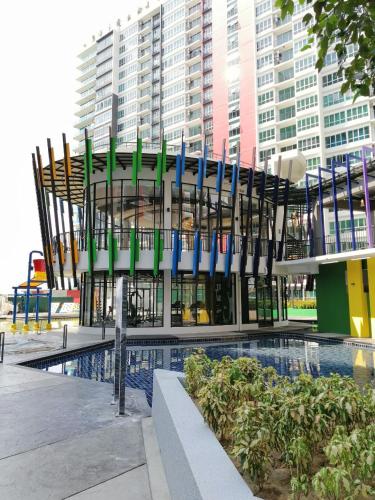 a building with a pool in front of a building at The Zizz Homestay@Damansara Damai in Petaling Jaya