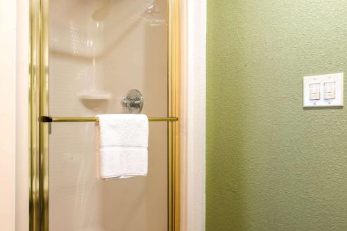 a towel hanging on a shower door in a bathroom at Sleep Inn & Suites Columbus South in Columbus