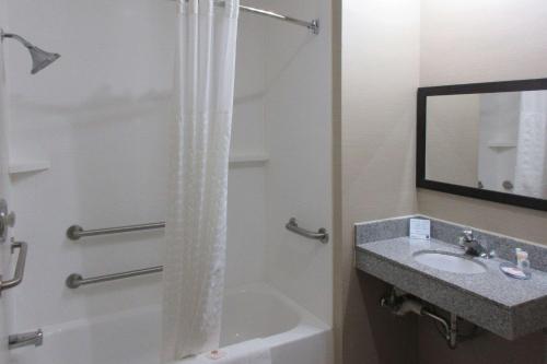 a bathroom with a shower and a sink and a tub at Comfort Inn Port Huron in Port Huron