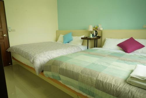 Una cama o camas en una habitación de TiAmo B&B Yilan
