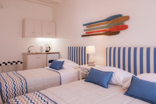 a room with two beds and a kitchen at Boufounis Studios in Kamarai