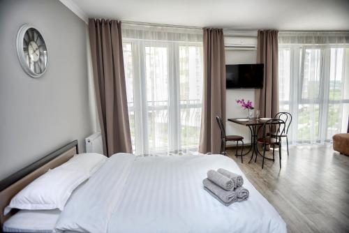 a bedroom with a large bed with towels on it at Apart Reserve Sloboda Loft in Ivano-Frankivsk