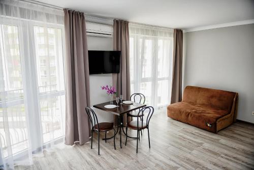 a living room with a table and a couch at Apart Reserve Sloboda Loft in Ivano-Frankivsʼk