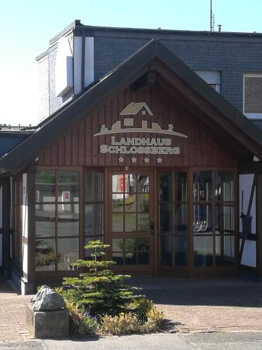 a building with a sign on the front of it at Landhaus Schlossberg in Medebach