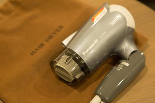 a close up of a hair dryer on a table at Laon Inn Gion Nawate in Kyoto