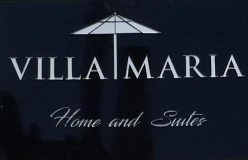 a sign that says villa marina with an umbrella at Villa Maria in Capitólio