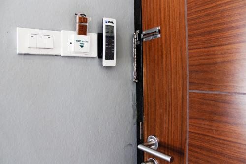 an open door with a phone on the wall at 3 Laan House in Chiang Mai