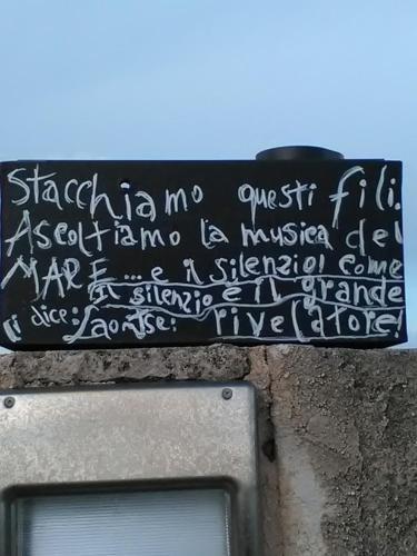 a sign with writing on the top of a tv at B & B Monte Adamo in Conversano