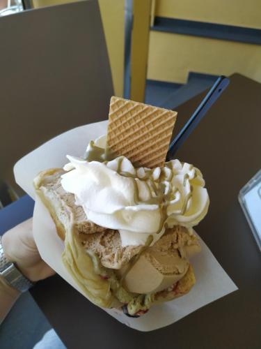 a ice cream sandwich with whipped cream and a cone on it at Aspra al delfino blu in Bagheria
