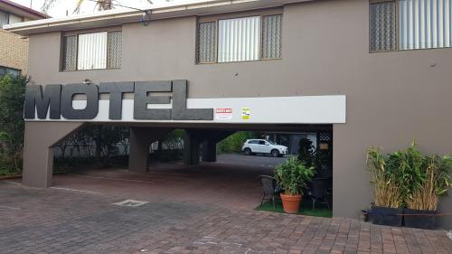 a motel sign on the side of a building at Gold Coast Airport Motel - Only 300 Meters To Airport Terminal in Gold Coast