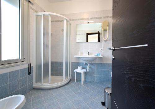 a bathroom with a shower and a sink at Hotel Bristol in Caorle