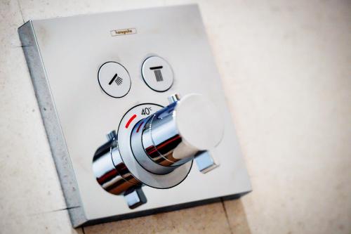 a close up of a lightswitch with eyes and a speaker at Oliver Lux in Tihany