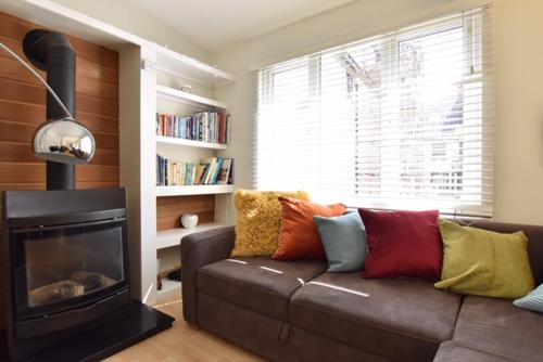 a living room with a couch and a fireplace at Keeley House in Exeter