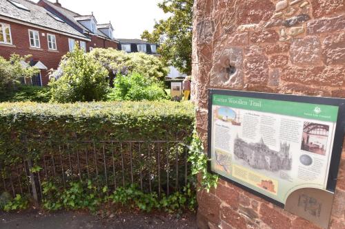 a sign on the side of a brick wall at Keeley House in Exeter