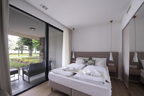 a bedroom with a bed with towels on it at Oliver Lux in Tihany