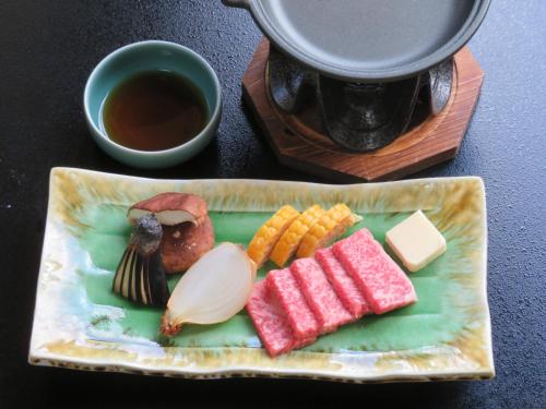 a plate of food with meat and vegetables on a table at Kashoutei Hanaya in Noboribetsu
