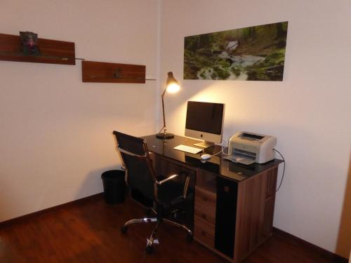 an office with a desk with a computer and a printer at Hotel Am Sportpark in Duisburg